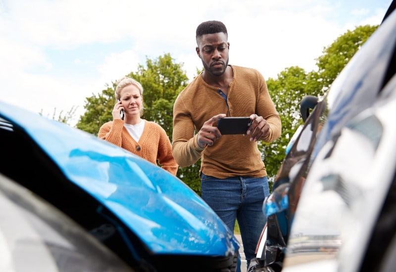 A Male Motorist Gathering Key Evidence Needed to Prove a Car Accident Claim